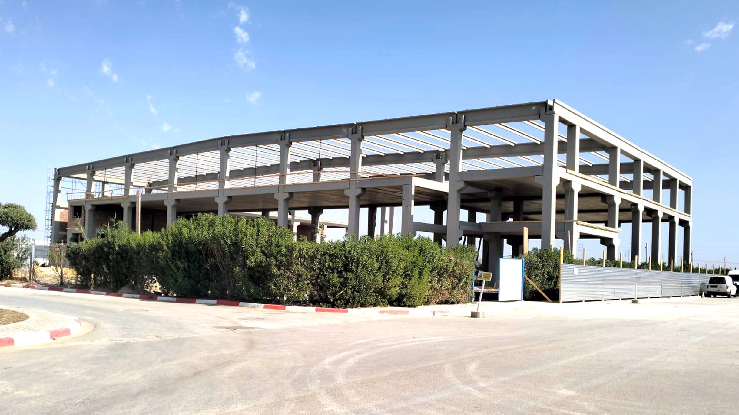 Industrial building with a precast concrete frame during construction.