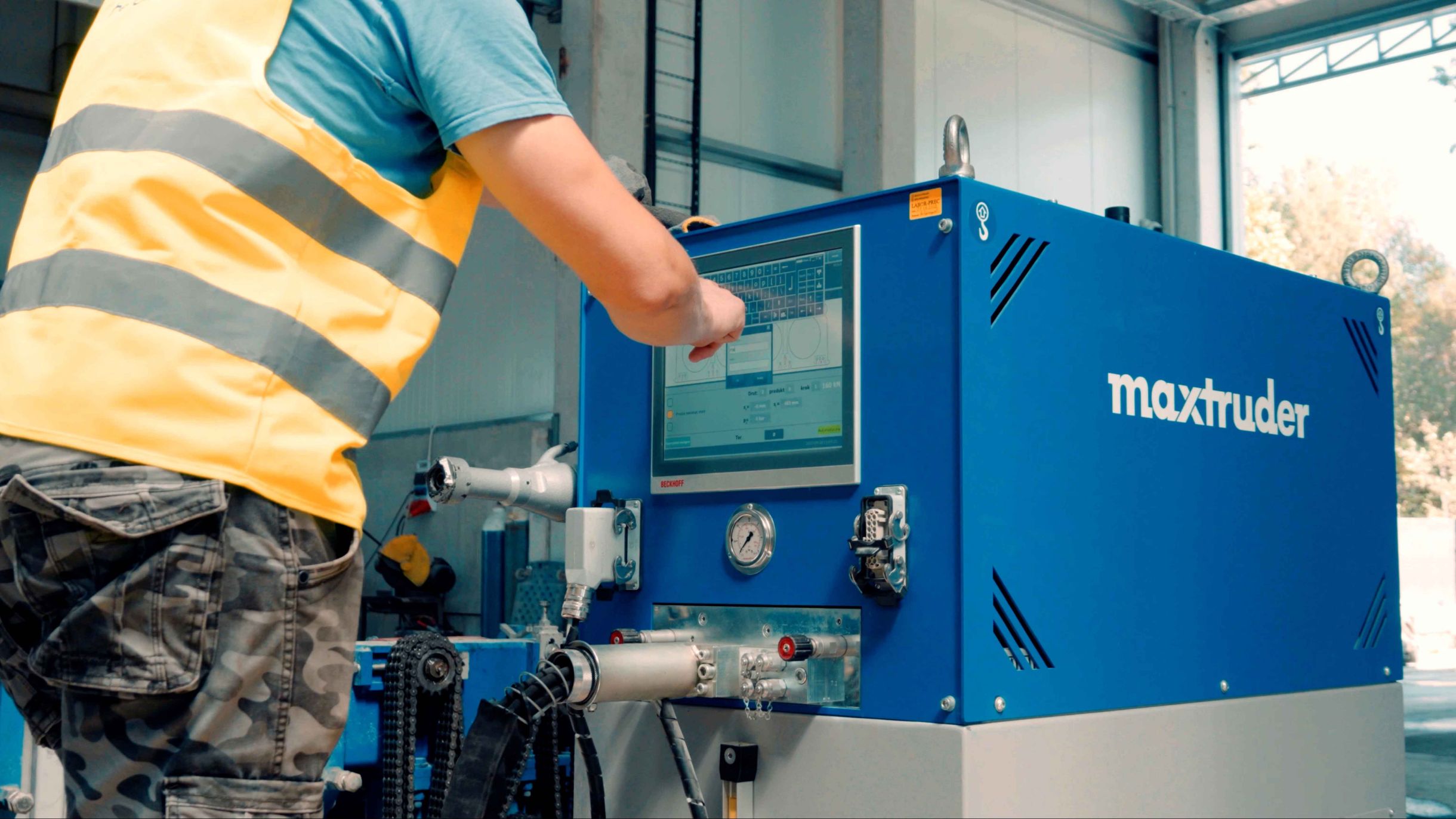 Operator uses the MAX-truder maxtension smart control unit for precise prestressing of reinforcement wires.
