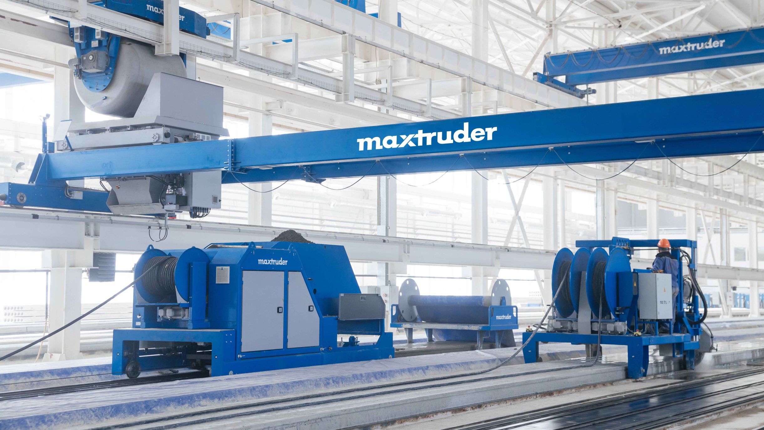 Production hall with several machines from the brand MAX-truder for manufacturing hollowcore slabs.